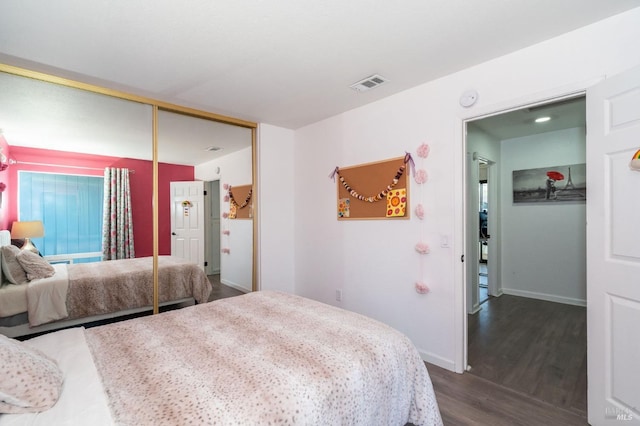 bedroom featuring a closet and dark hardwood / wood-style floors