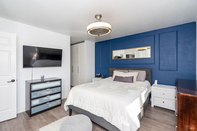 bedroom featuring wood-type flooring and ceiling fan