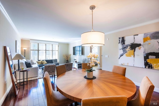 dining area with dark wood-type flooring and crown molding