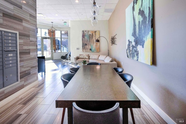 dining area with a paneled ceiling