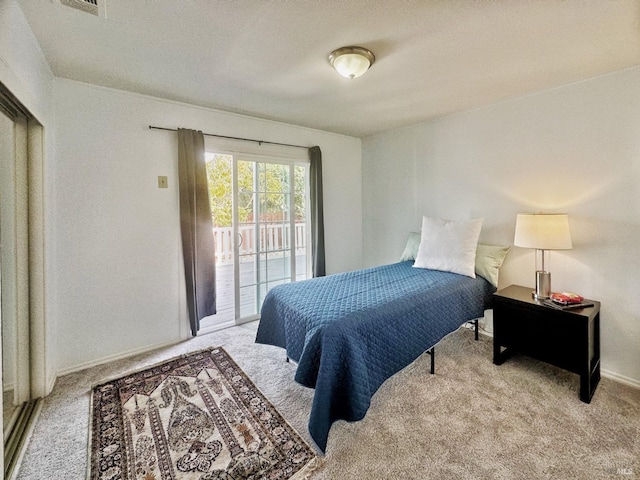 carpeted bedroom featuring access to outside