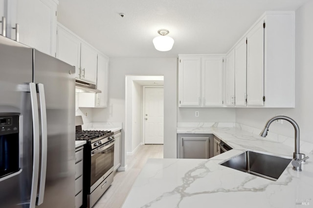 kitchen featuring sink, stainless steel appliances, white cabinets, and light stone countertops