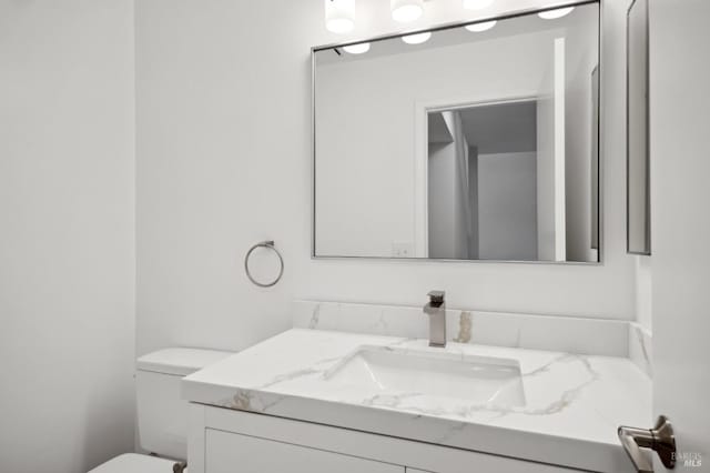 bathroom with toilet and vanity