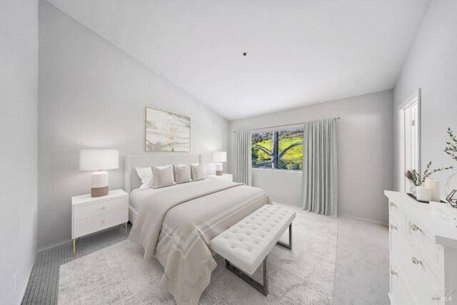 bedroom featuring vaulted ceiling and light colored carpet