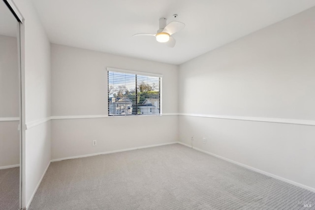 carpeted empty room with ceiling fan