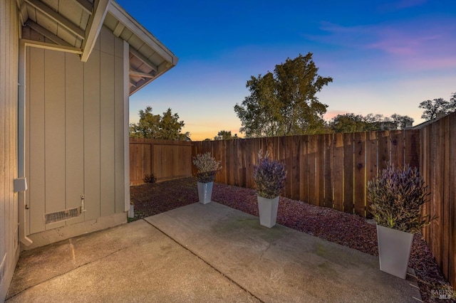 view of patio terrace at dusk