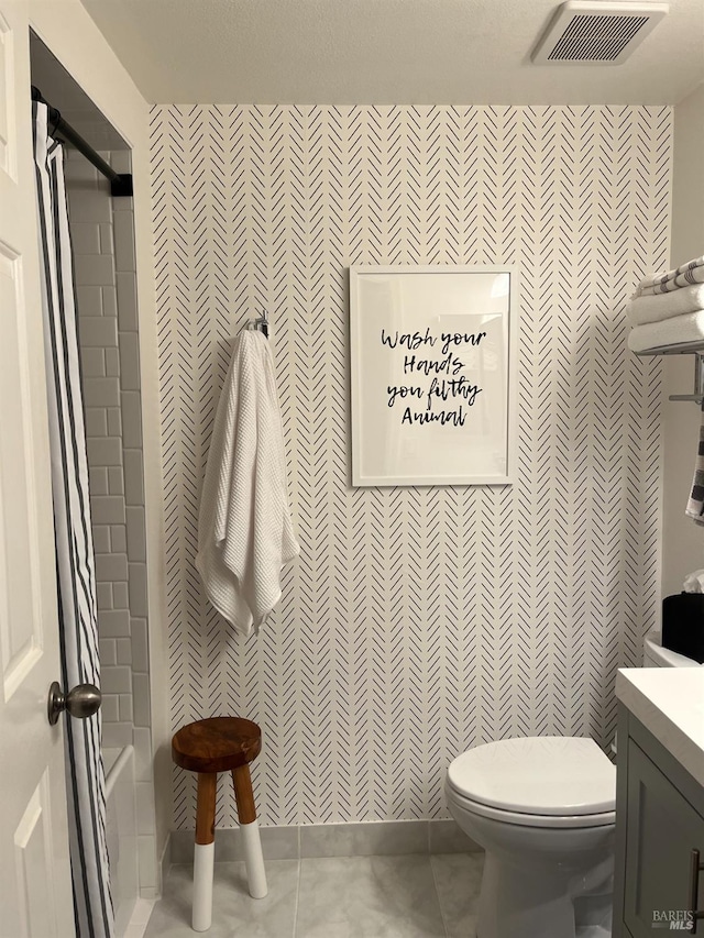 full bathroom with toilet, vanity, tile patterned floors, and shower / tub combination