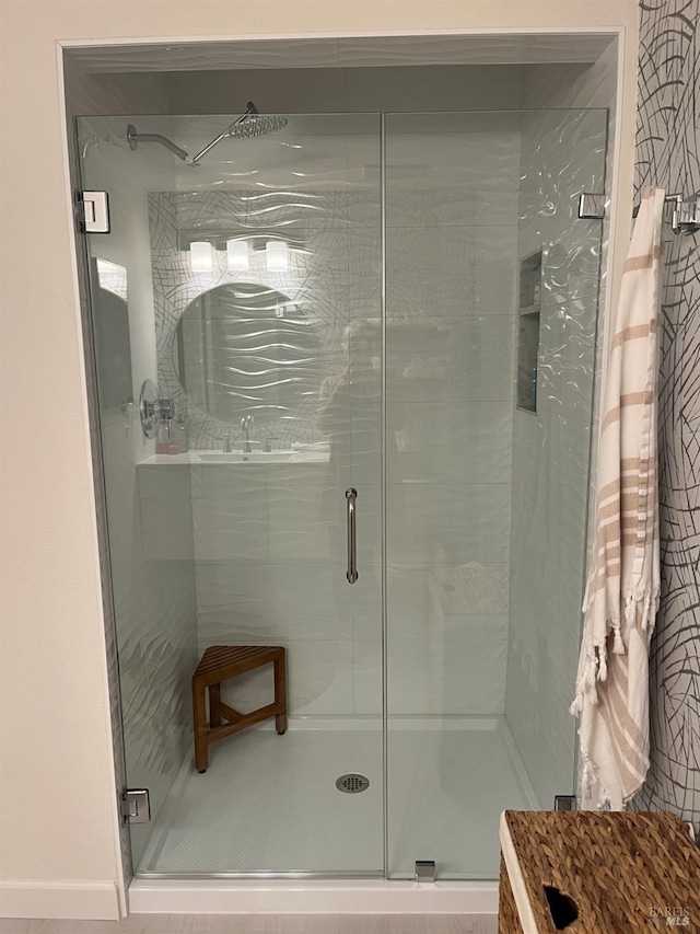 bathroom with a shower with shower door