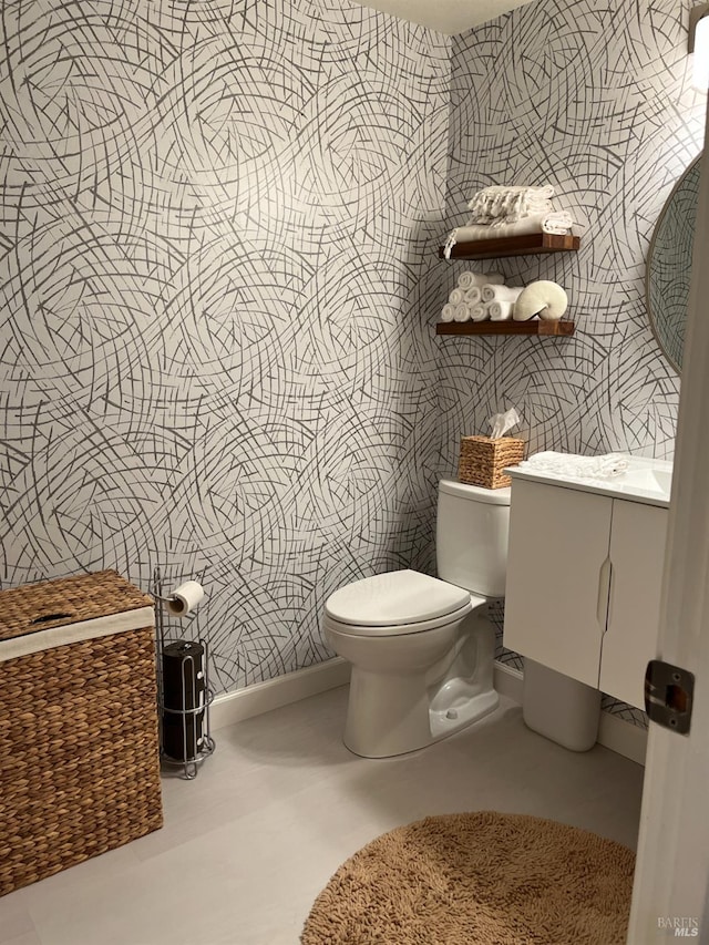 bathroom featuring toilet and vanity