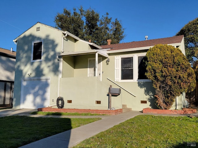 view of front of house with a front yard and a garage