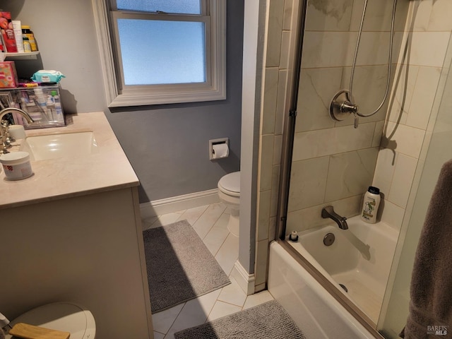 full bathroom featuring vanity, tile patterned flooring, tiled shower / bath combo, and toilet