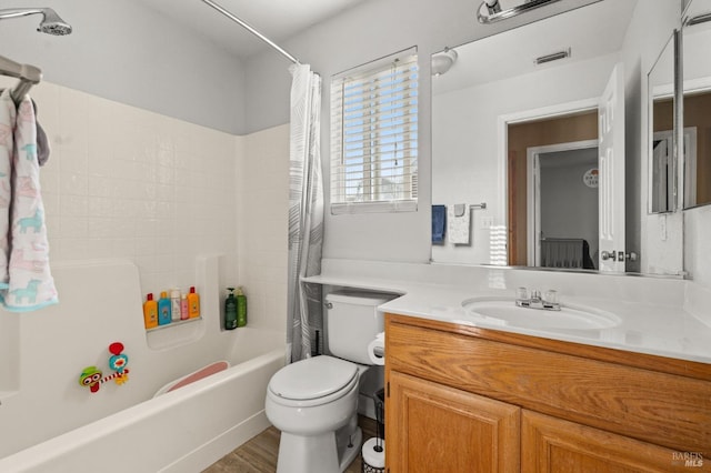 full bathroom with vanity, shower / bath combination with curtain, and toilet