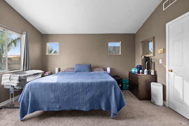 bedroom with vaulted ceiling and light carpet