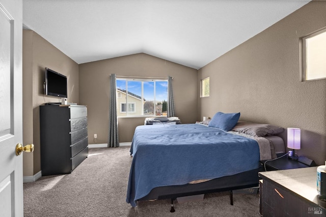 carpeted bedroom featuring lofted ceiling