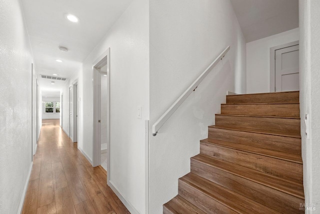 staircase with wood-type flooring