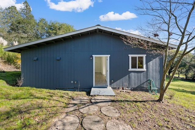 back of property featuring a lawn