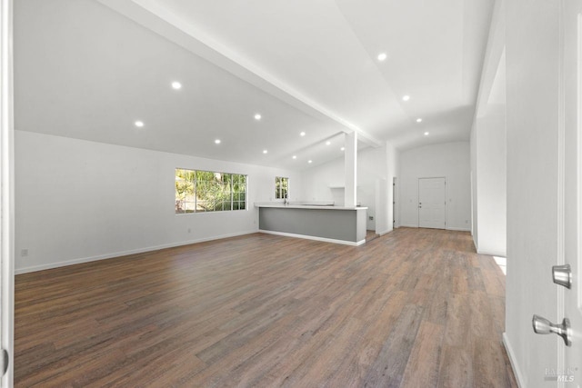 unfurnished living room with lofted ceiling and dark hardwood / wood-style flooring