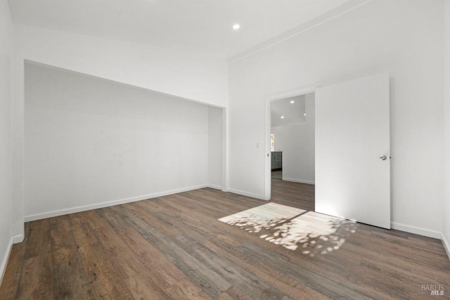 spare room featuring dark wood-type flooring