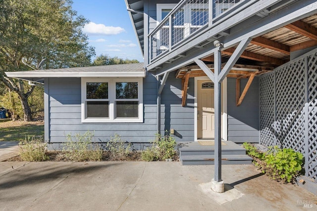 property entrance featuring a balcony and a patio area