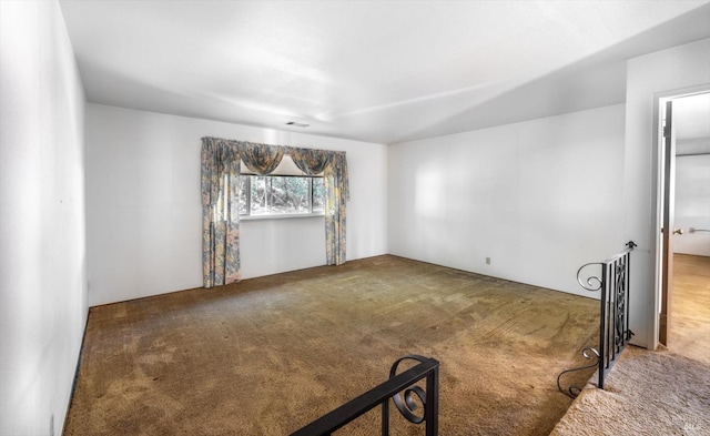 unfurnished room featuring carpet floors and visible vents