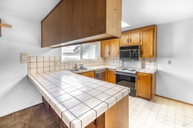 kitchen with black microwave, electric stove, light floors, and tile counters