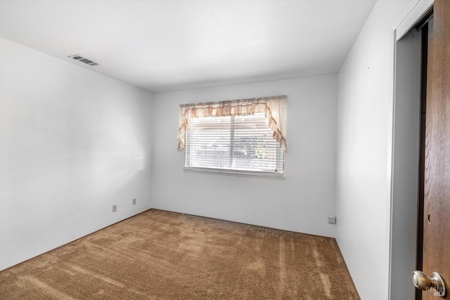 empty room featuring carpet and visible vents