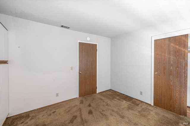 carpeted spare room with visible vents