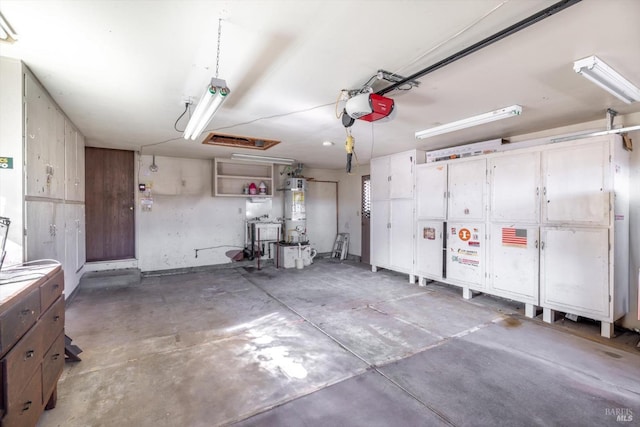 garage featuring water heater and a garage door opener