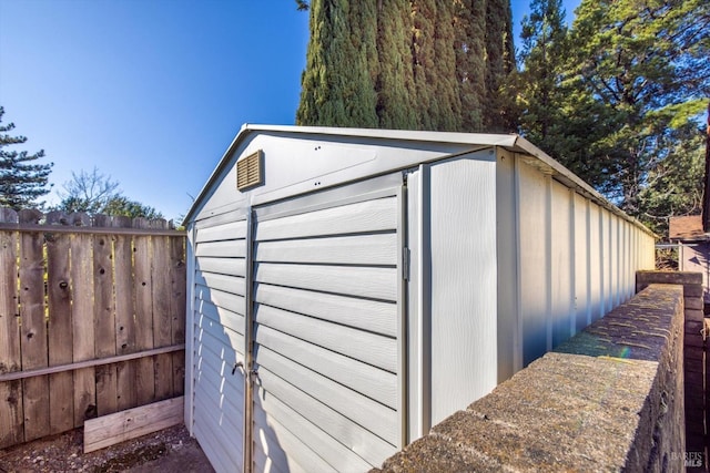 view of shed featuring fence