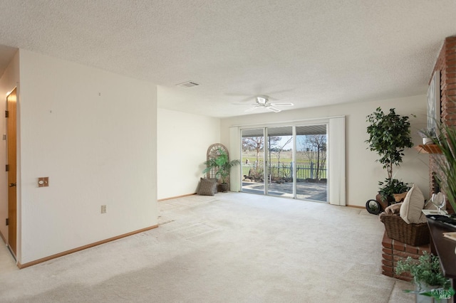 interior space with ceiling fan and a textured ceiling