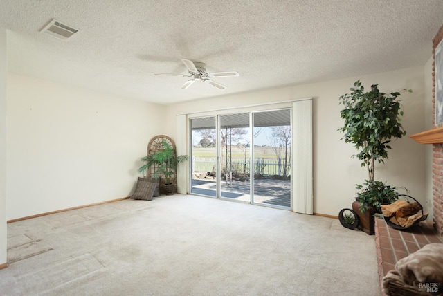 carpeted spare room featuring a textured ceiling and ceiling fan