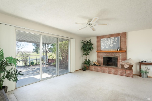 living room with a textured ceiling, a brick fireplace, carpet floors, and ceiling fan