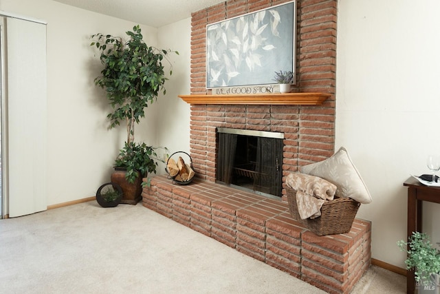 living room with a brick fireplace and carpet floors