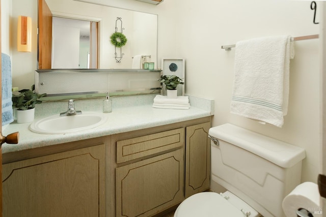 bathroom with toilet and vanity