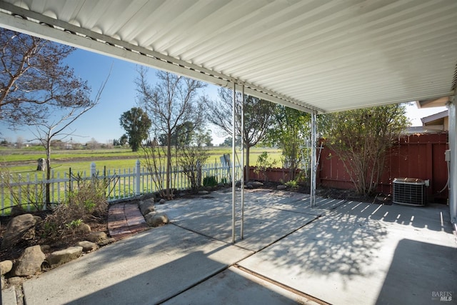 view of patio with a rural view and central air condition unit