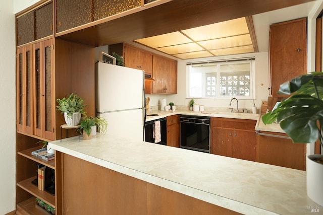 kitchen featuring electric range oven, black dishwasher, white refrigerator, and sink