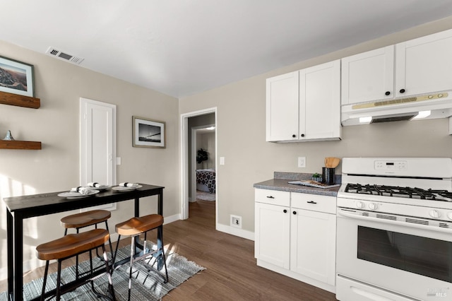 kitchen with white cabinetry, white range with gas cooktop, and dark hardwood / wood-style floors