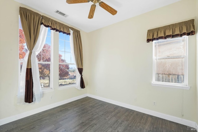 empty room with ceiling fan and dark wood-type flooring