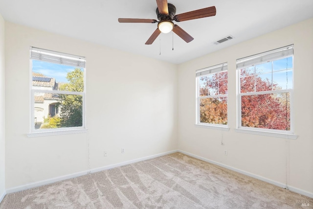 carpeted empty room featuring ceiling fan