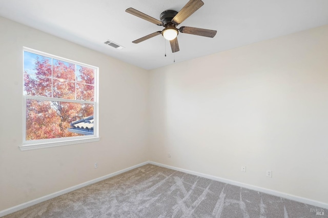 carpeted empty room featuring ceiling fan and a healthy amount of sunlight