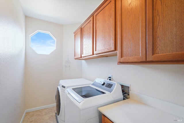 laundry room featuring cabinets and separate washer and dryer