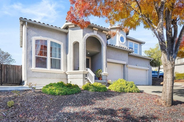 mediterranean / spanish-style house with a garage