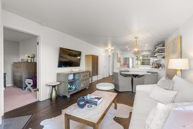 living room featuring dark hardwood / wood-style floors and a chandelier