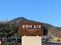 community / neighborhood sign with a mountain view