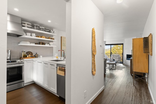 kitchen with sink, white cabinetry, stainless steel appliances, dark hardwood / wood-style floors, and island exhaust hood