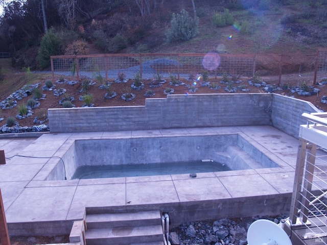 view of pool with a hot tub and a patio