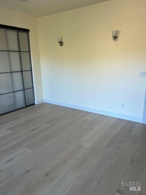 empty room with light hardwood / wood-style flooring