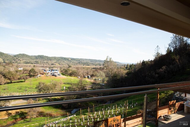 back of house featuring a balcony and a patio