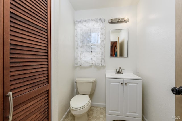 bathroom with toilet and vanity