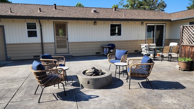 back of house featuring a patio area and a fire pit